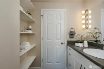 Powder room bath features great storage shelved area, updated cabinetry & fixtures