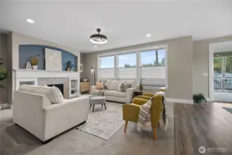 Spacious main living area designed for comfort, with a warm fireplace focal point and an open, functional layout