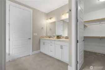 Primary bath includes dual vanities and direct access to a walk-in closet for added everyday functionality