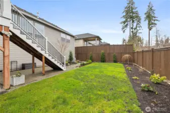 Thoughtfully designed outdoor space with deck access, open lawn, and a clean, low-maintenance layout