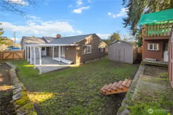 the backyard is tiered, up the little staircase to the shed and playhouse