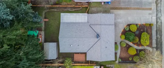 this shot shows off the new roof, outbuildings, deck and manicured front yard