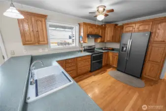 through the swinging door to the large kitchen