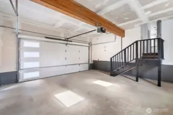 Large 2-car garage with extra storage space and gated driveway with extra parking