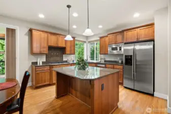 Granite counters and stainless appliances plus a large breakfast bar island for extra seating