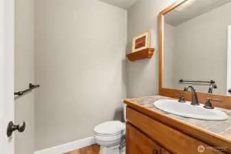 Convenient half bath on the main level is convenient  for all, near the heart of the home.