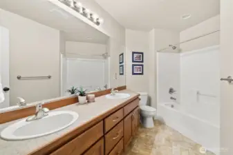 Full main bath with dual sinks and tub/shower combo upstairs