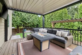 The sliding glass door off the kitchen leads to the covered backyard deck. The deck cover is louvered and opens electronically. Great for year-round use.
