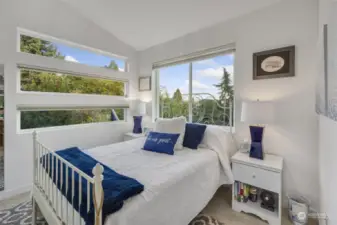 Upper-level guest bedroom with views of the Cascades & Mt. Rainier.