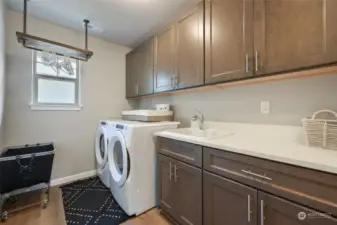 Generous and well functioning laundry room has great storage and conveniently located upstairs too.