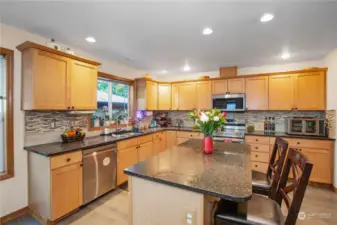 Great size kitchen w/ lots of cabinet and counter space. Full height backsplash and Beautiful Granite tops!