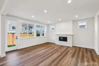 Great room warmed by a gas fireplace hosts entry to covered patio in private fully landscaped and fenced rear yard-photo is of similar plan-finishes, features and inclusions can vary