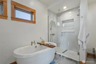 Renovated primary bathroom with a deep soaker tub