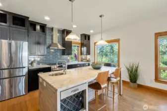 Eat in kitchen counter including a sink with garbage disposal and wine rack