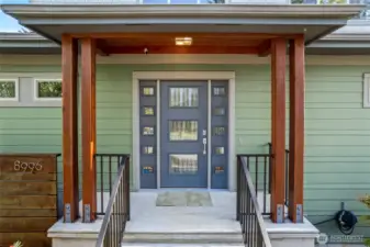 Front door and porch leading to an additional door to access the mudroom/pantry/kitchen