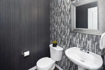 Downstairs powder room with custom tile and designer wallpaper.  Beautiful!