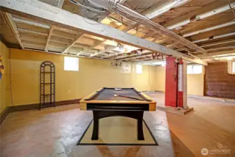 Partially finished rec room downdstairs with heated concrete floor & new windows.