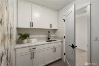Laundry Room: Upper-level laundry includes cabinetry, sink, and counter workspace for added functionality. Washer and dryer not included, allowing buyers to select appliances that fit their needs.    Photos are from THIS model home at Foxmoore but are for visualization purposes only.