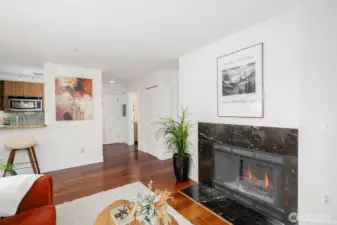 Fireplace creates instant ambiance while the open layout flows seamlessly from living to dining to kitchen.