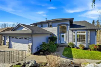 Follow the walkway along the right side of the home, past blueberry bushes and lush professional landscaping, to the backyard and private entrance to the daylight ADU.