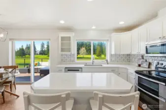 What catches your eye first, the quartz counters and marble tile backsplash, stainless appliances, or the sweeping green fairway views outsisde?