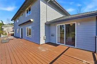 Private sliding door from the main-level primary suite opens directly to the expansive deck, creating an easy indoor-outdoor retreat.