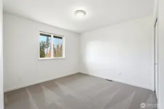4th Light-filled upstairs bedroom with peaceful outlook toward the golf course.
