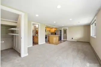 Spacious daylight basement ADU living area with full kitchen, open living space, and access to two bedrooms. Ideal for guests, extended living, or rental income.