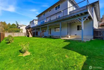 Fully fenced yard with space for pets, play, and outdoor fun.