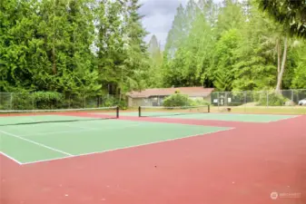 View of tennis courts with clubhouse in the background