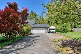 Long driveway with extra parking pad.