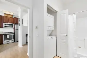 Stackable washer and dryer in bath closet.