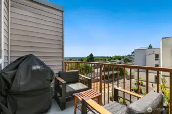 Private balcony space sits off main living room and overlooks 2nd outdoor patio space, also with BBQ area.
