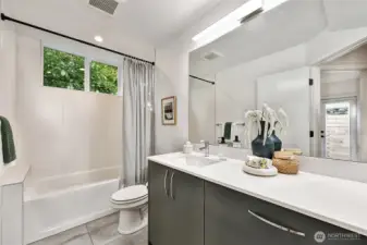 Full-size bathroom with bathtub on entry level.