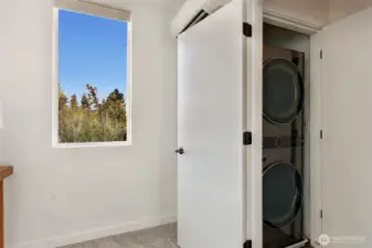 HE washer and dryer adjacent to primary suite.