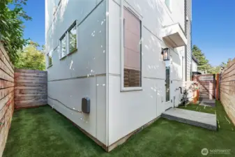 Turfed yard is low maintenance, and there is extra storage space here for bikes or paddleboards.