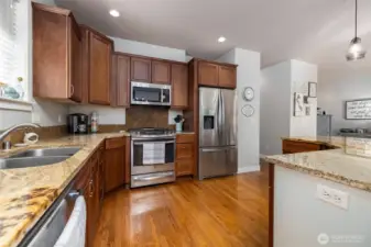 This kitchen is thoughtfully designed, with room for multiple cooks.  Stainless appliances complement the wood cabinets and granite counters.