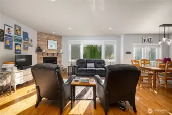 Great room, with those gorgeous oak floors, a gas fireplace, and dining area to the right.