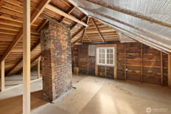 The unfinished attic is accessed by stairs off the bedroom/den.