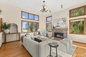 Entering on the main floor of the home and greeted by the formal living room. With soaring ceilings, a wood-burning fire-place and a wall of windows to take in the views- you will love spending time in this room!