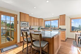 The heart of the home is a sunny, bright and cheerful kitchen with SS appliances, convenient counter seating, a kitchen dining area and handy access to one of the two entertainment sized decks.