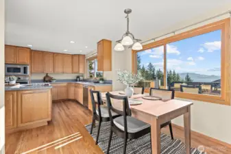 Kitchen dining area flows effortlessly into the formal dining room. Look at those views!