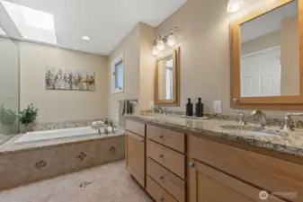Primary bath has beautiful maple built-in cabinets for amazing storage! Double vanity, seperate WC, a soaking tub and walk-in shower with custom tile will make you feel like you are at the spa!