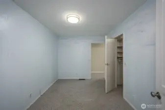 Bedroom 1. This room could easily be used for an office. It has two doors, one accessing the hall with the bedrooms and the other door is close to the kitchen.