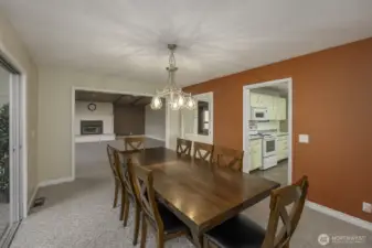 Large dining room with a view to the family room and the sunroom to the left.