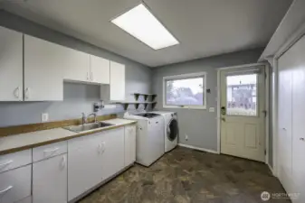 Laundry room with lots of storage and a very handy sink!