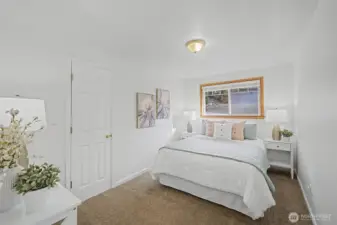 First guest bedroom on the left with wall-to-wall carpet.