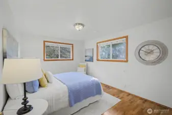 Second guest bedroom with hardwood floors and abundant natural light.