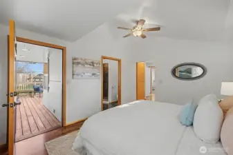 Primary suite with laminate flooring, private access to the covered porch, and direct entry to the ensuite bath and walk-in closet, offering a comfortable and well-designed owner’s retreat.