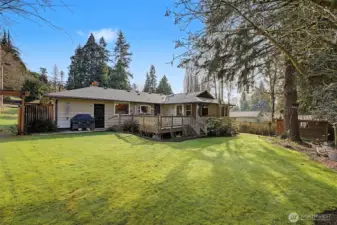 Elevated deck overlooking a level, usable yard, seamlessly connecting indoor living to outdoor entertaining space.
